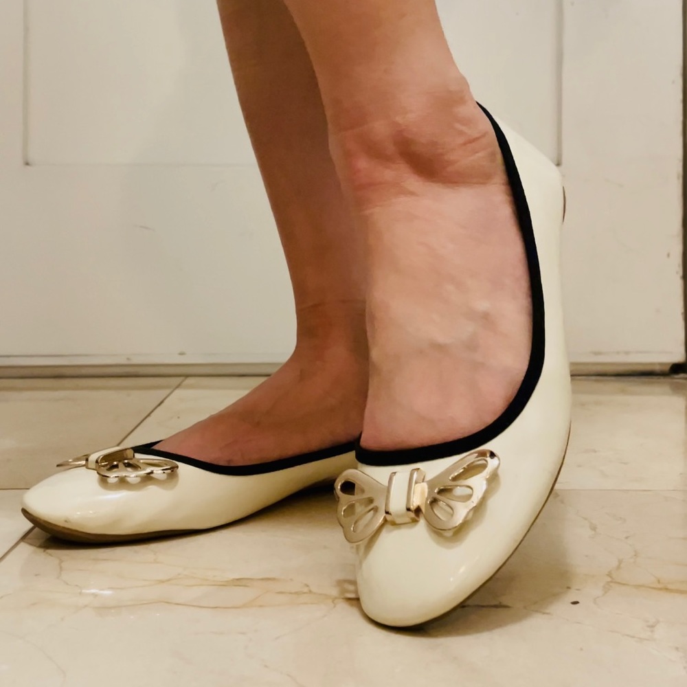 White ballet flats with golden butterfly accent